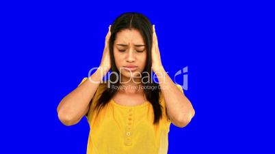 Upset woman shaking head in denial on blue screen