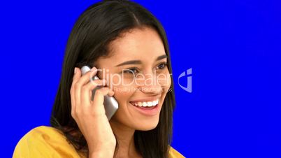 Woman talking on the phone on blue screen