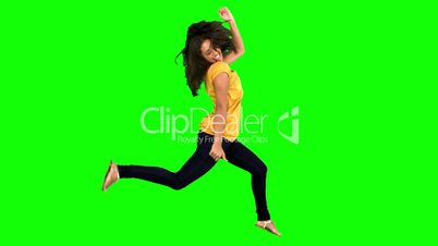 Cheerful woman jumping with legs and arms raised
