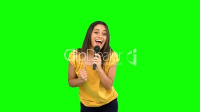 Woman singing and dancing on green screen