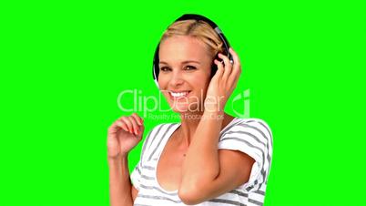 Smiling woman pointing at the camera on green screen