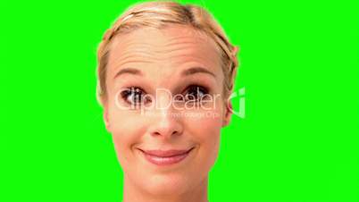 Woman smiling and looking at the camera on green screen