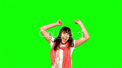 Brunette woman jumping on green screen