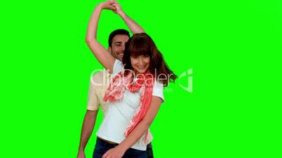 Cute couple dancing on green screen