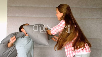 Young siblings having a pillow fight 