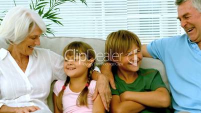 Children with grandparents on the couch
