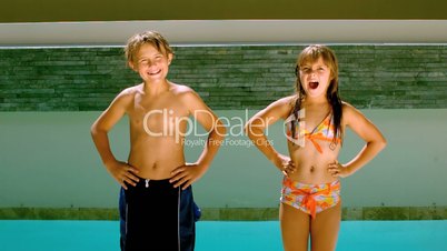 Siblings dancing and diving into the swimming pool