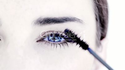 Woman making up her eye with mascara
