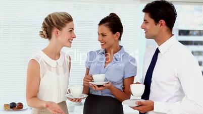 Laughing business people having a conversation at break time