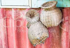 Handmade wicker baskets for fish hanging on wall