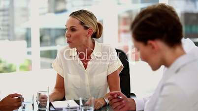 Irritated businesswoman giving out to colleagues