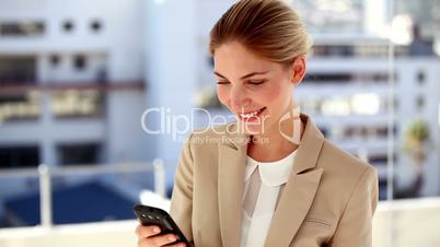 Portrait of smiling businesswoman text messaging