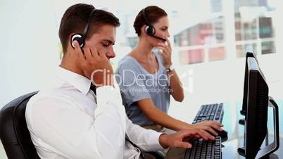 Business man and business woman in a call centre