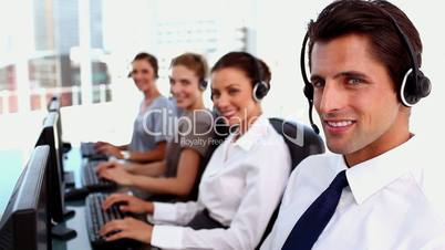 Smiling call centre agent working