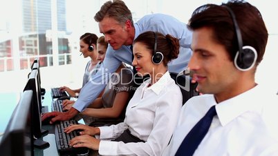 Smiling business people working in a call centre