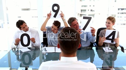 Business team giving grade to a businessman