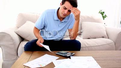 Man stressed with so many bills to pay