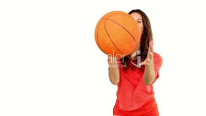 Woman catching a basketball on white background
