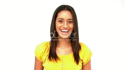 Confused woman being surprised then laughing on white background
