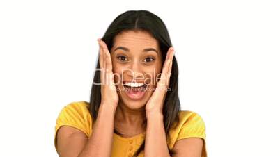 Surprised woman holding her head on white background