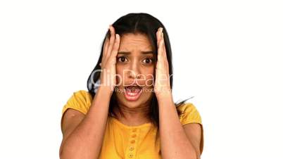 Shocked woman putting hands on head on white background