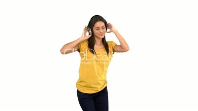 Woman dancing with headphones on white background