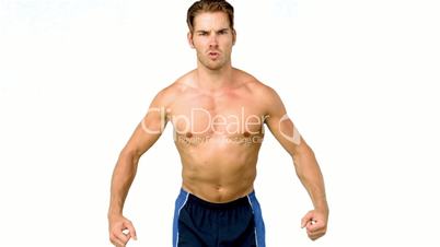 Shirtless serious man flexing muscles