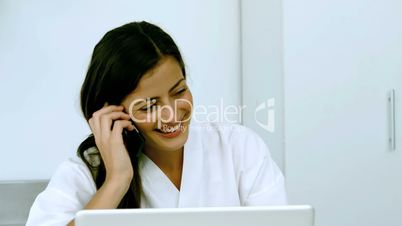 Woman laughing during a phone conversation