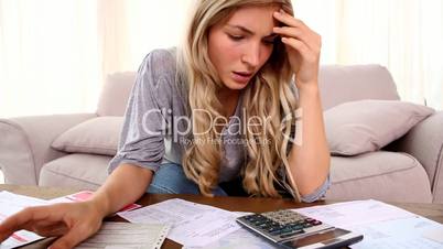 Blonde woman stressing over accounts