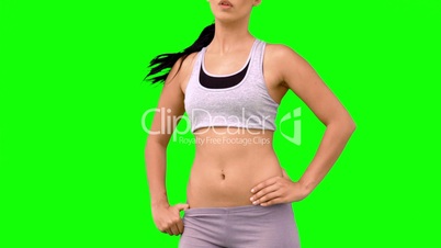 Athletic woman tossing hair on green screen