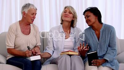 Three mature friends praying together