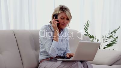 Woman on the phone using laptop