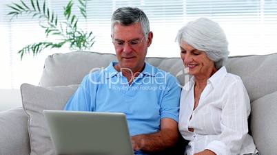 Retired couple using laptop together