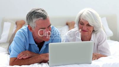 Mature couple using laptop together