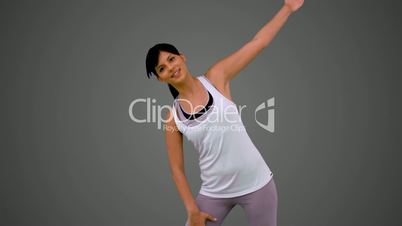 Fit brunette stretching arm