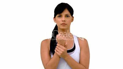 Fit woman massaging her wrist