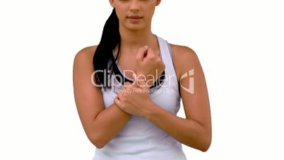 Fit woman massaging her sore wrist