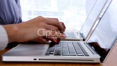 Close up of hands typing on laptop