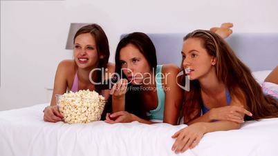 Friends eating popcorn and watching tv