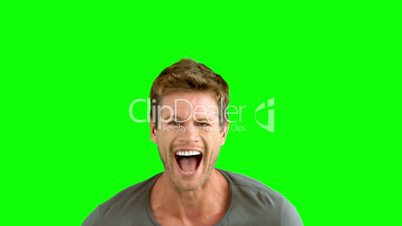 Handsome man laughing on green screen