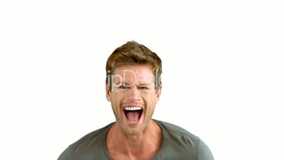 Handsome man laughing on white background