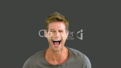 Man laughing on grey screen