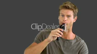 Man with microphone singing on grey screen