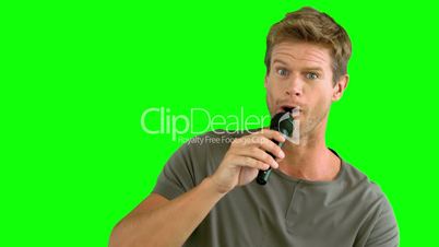 Man with microphone singing on green screen