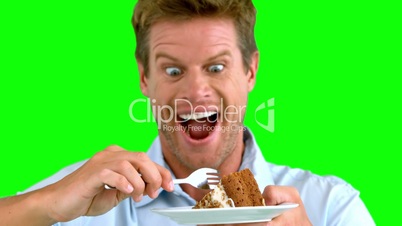 Attractive man about to eat a cake on green screen