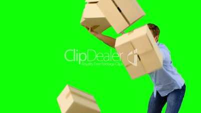 Clumsy man dropping boxes down on green screen