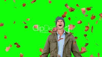 Amazed man looking at falling leaves on green screen
