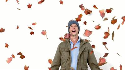 Amazed man looking at falling leaves on white screen