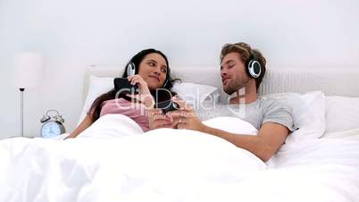 Couple listening to music on headphones