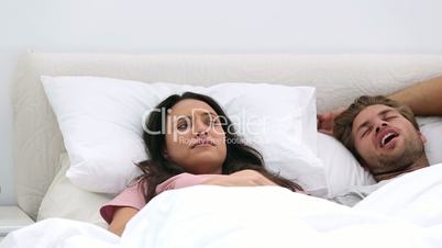 Woman annoyed by her husbands snoring